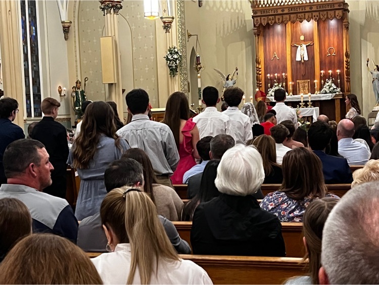 students standing in church facing the altar