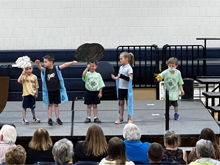 students standing on stage wearing costume